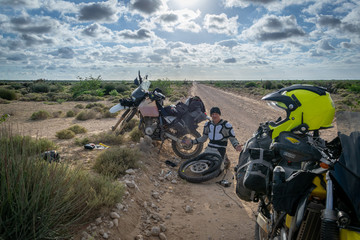 Fixing a flat tire in Baja Mexico on a dual sport motorcycle. 