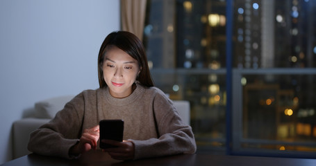 Canvas Print - Young woman use of mobile phone at night