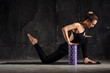 © Admiral - Fitness woman doing stretching, warming up, pilates exercises using foam roller