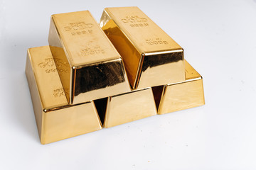 Wall Mural - Five gold bars. Gold bars of 1 kg or 1000 grams. Gold bars are on the table.