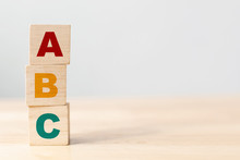 ABC Letters Alphabet On Wooden Cube Blocks In Pillar Form On Wood Table