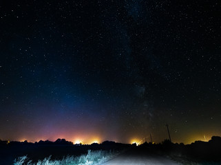 Wall Mural - The starry sky and the bright milky way above the village.