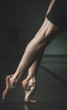 Ballerina in studio dancing bare foot on pointe