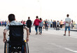 © GAYSORN - Portrait of Disabled child on wheelchair, Public bridge background with blurry, Special children’s enjoying outdoor activity at a normal life,Life in the education age ,Happy disability kid concept.