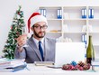 © Elnur - Young businessman celebrating christmas in the office