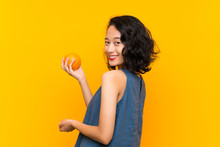 Asian Young Woman Holding An Orange