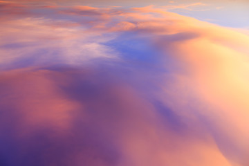 Wall Mural - Abstract fantasy softly colorful mountain clouds background, Gold fog with sun highlight on blue sky and moving cloud before sunset by airal view