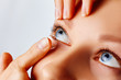 © Olesia - Young woman puts contact lens in her eye. Eyewear, eyesight and vision, eye care and health, ophthalmology and optometry concept