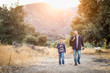 © Andy Dean - Mixed Race Father And Son Outdoors Walking With Fishing Poles