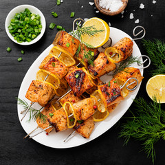 Wall Mural - Baked salmon skewers with lemon and green onion.