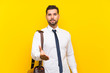 © luismolinero - Handsome businessman over isolated yellow background handshaking after good deal
