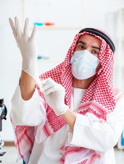 Wall Mural - Arab chemist working in the lab office