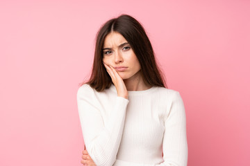 Wall Mural - Young woman over isolated pink background unhappy and frustrated