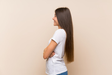 Wall Mural - Pretty young girl over isolated background in lateral position