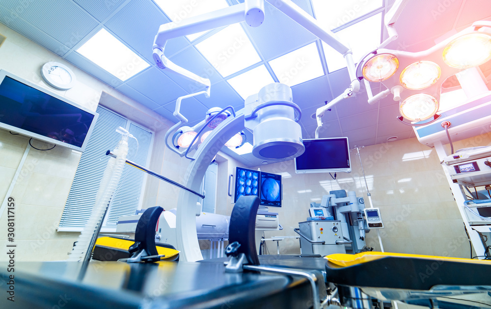 Clinic interior with operating surgery table, lamps and ultra modern ...