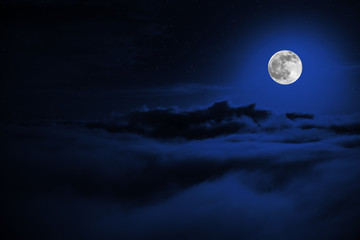 Wall Mural - Shone circle of the moon in darkness on a background of the star sky and clouds