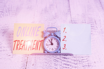 Conceptual hand writing showing Online Treatment. Concept meaning delivery of mental health counseling via the Internet Mini blue clock standing above buffer wire between two paper