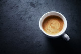 Fototapeta Mapy - Cup of coffee on dark stone background. Close up. Copy space
