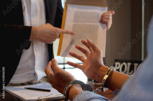 Fototapeta na szkło The police conducted an investigation. Inquiring about the violation of state laws Arrest the culprit offender Handcuffing