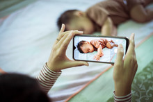 Mother Hands Taking A Picture To Baby Boy With Smart Phone,Family Memory Concept,