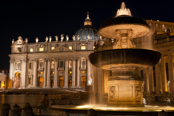 Italy, Rome,: view of the fountain in St. Peter's Square on the background of St. Peter's Basilica in the Vatican at night. Long exposure.