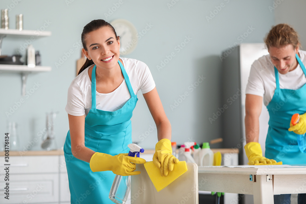 Team of janitors cleaning kitchen