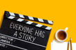 Everyone has a story.text title on movie clapper board  and coffee cup on yellow background