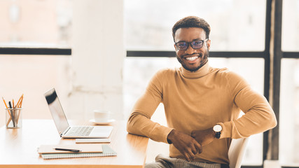 Poster - Happy african american man sitting with laptop