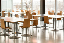 Interior Of Empty Canteen With Tables And Chairs