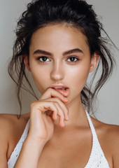 Wall Mural - portrait of beautiful model on a grey background in the studio