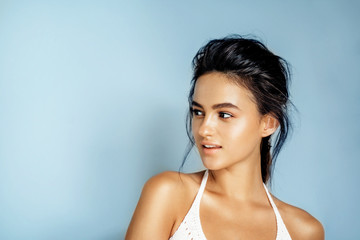 Wall Mural - portrait of beautiful model on a blue background in the studio