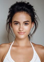 Wall Mural - portrait of beautiful model on a grey background in the studio