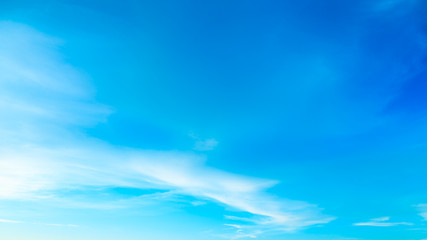 Wall Mural - Fantasy abstract turquoise color tone background, Flare sunlight on blue sky and soft white cloud before sunset