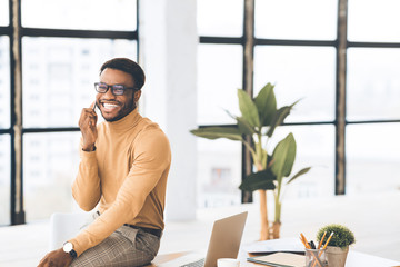 Poster - Black guy talking on phone sitting on the table