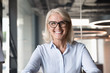 © fizkes - Headshot of middle-aged businesswoman posing at workplace