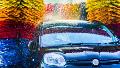 Wall Mural - Car going through an automated car wash machine