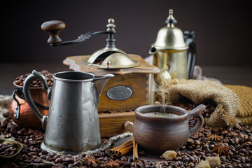 Coffee beans are roasted in a pan with smoke.