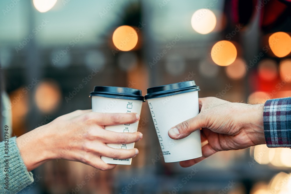 a couple is toasting with paper cup and drink coffee - obrazy, fototapety, plakaty 