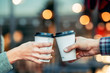 © Sondem - a couple is toasting with paper cup and drink coffee