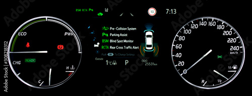 Illuminated car dashboard panel with speedometer, power meter, odometer, fuel and temperature gauge. Modern car display showing advanced driver assistance systems. Car counter in hybrid car.