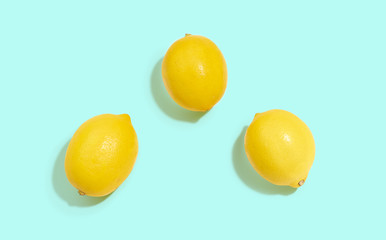 Fresh lemons isolated on bright blue background