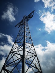 high voltage tower on background of blue sky