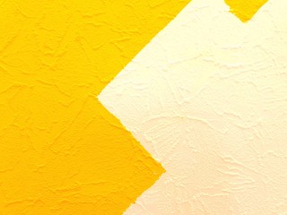 The texture of the wall is painted in two bright colors. The wall is painted in white and yellow.