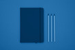 Close up leather cover notebook flat lay over blue