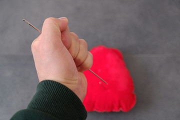 Wall Mural - red pincushion and a large sewing needle, needle spell,