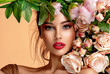 Leinwandbild Motiv Beautiful white girl with flowers. Stunning brunette girl with big bouquet flowers of roses. Closeup face of young beautiful woman with a healthy clean skin. Pretty woman with bright makeup