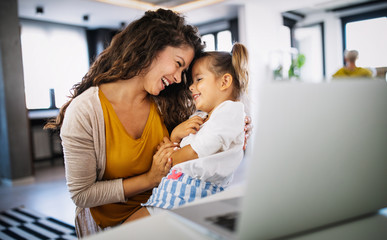 Wall Mural - Mother at home trying to work with child distracting her