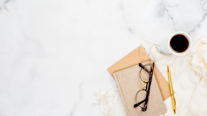 Stylish feminine accessories and office supply on marble background. Flat lay, top view. Beauty blogger workspace concept.