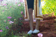 Thai students, bachelor degree students, stand in a garden on the ground where flowers wear white shoes