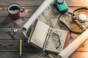 Aufkleber - A map spread out on the table with a cup of hot tea and useful items for the trip. Vintage style. Place for your own text